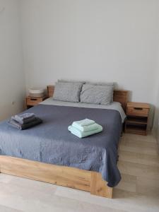 a bedroom with a bed with two towels on it at Anastasia in Kyparissia