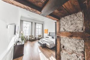a living room with a bed and a couch at Hotel Münchner Hof in Altötting +54 photos