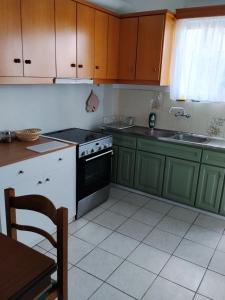 a kitchen with green cabinets and a stove top oven at Anastasia in Kyparissia +17 photos