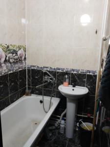 a bathroom with a bath tub and a sink at ИП Саялы in Balqash