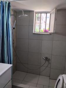 a bathroom with a shower with a glass door at Anastasia in Kyparissia