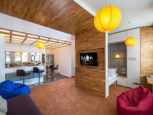 a living room with a couch and a tv and a table at VIP apartment 40 in Lviv