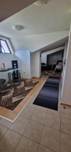 an empty living room with rugs on the floor at Aspen golf studio B402 in Razlog