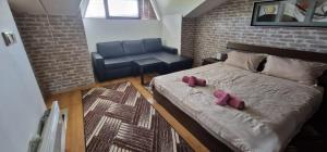 a bedroom with a bed with two pink pillows on it at Aspen golf studio B402 in Razlog