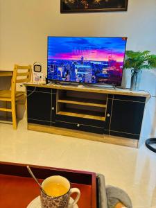 a living room with a tv and a cup of coffee at The Tranquil Nook in Mandaue City