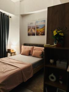 a bedroom with a bed with two posters on the wall at The Tranquil Nook in Mandaue City +11 photos
