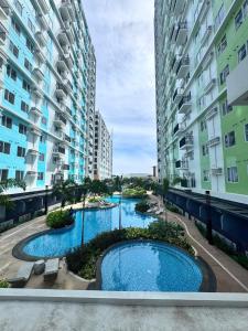 a view of two pools between two buildings at The Tranquil Nook in Mandaue City