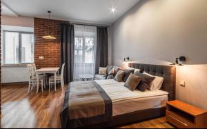 a bedroom with a large bed and a dining room at VIP apartment 40 in Lviv