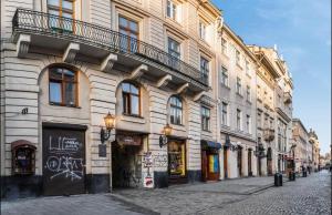 a building with a balcony on the side of a street at VIP apartment 40 in Lviv