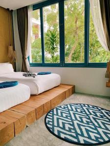 two beds in a room with a large window at In Touch Resort in Ko Tao +93 photos