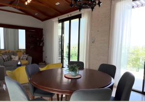 a dining room with a wooden table and chairs at Zahret Al Roman in Sayq