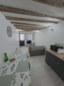 a living room with two tables and a couch at appartement calme et climatisé Chamaillard 2 in L'Ile-Bouchard