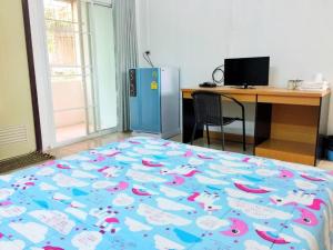 a bedroom with a bed and a desk and a computer deskictericter at Wanarom Resort in Ban Maklua Kao