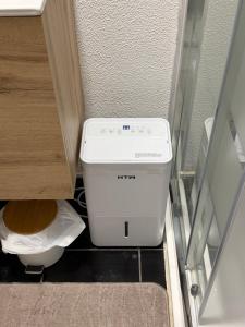 a bathroom with a toilet in a small room at LandS in Caniço