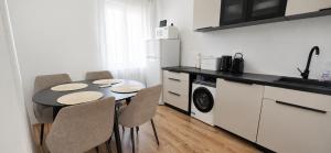 a kitchen with a table and chairs in a kitchen at Apartmani Luan in Vis