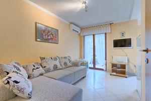 a living room with a couch and a tv at Apartments Valoda in Nedeščina