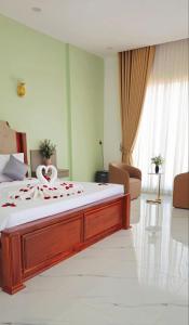 a large bedroom with a large bed with a white mattress at Soksan Nylen Hotel in Kampong Cham
