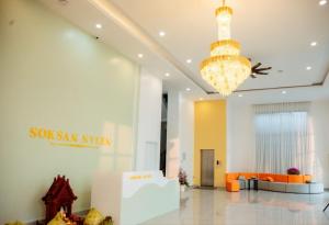 a lobby of a building with a chandelier at Soksan Nylen Hotel in Kampong Cham