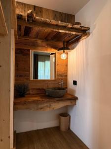 a bathroom with a sink and a mirror at DaSte' ex Villa Ruggero in Campitello di Fassa