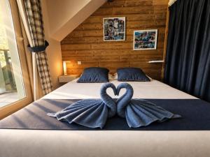 two towels in the shape of hearts on a bed at Appartement 202 Geroli Lac d'Annecy in Duingt