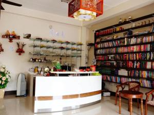 a bookstore with a book shelf filled with books at Donut Resort in Ban Dong
