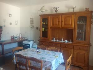a kitchen with wooden cabinets and a table with chairs at Casa Branchetti in Quarrata