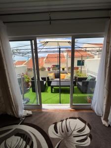 a living room with a large sliding glass door at LandS in Caniço