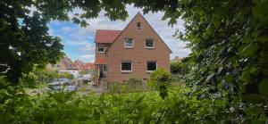 a brick house with a tower on top of it at Ferienwohnung Waldblick Bückeburg in Bückeburg