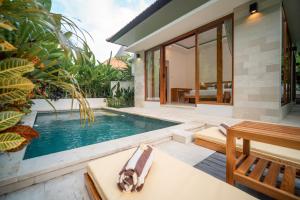 a pool in the backyard of a villa at River Temple Villa in Ubud