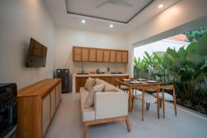 a kitchen and dining room with a table and chairs at River Temple Villa in Ubud