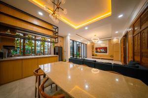 a dining room with a table and a couch at Bhumi Nawasena in Semalen