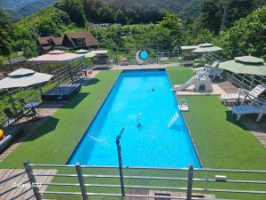a swimming pool with a person in the water at Gapyeong Ohneulharu Spa Pension Pet friendly in Gapyeong