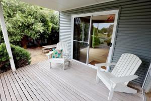 two chairs and a table on a wooden porch at 'The Perch' - Central location in Robe, park your car and walk to everything in Robe