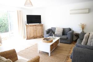 a living room with two couches and a tv at 'The Perch' - Central location in Robe, park your car and walk to everything in Robe