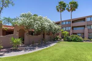 a building with a yard in front of a building at La Posada Lodge & Casitas, an Ascend Collection Hotel in Tucson