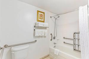 a bathroom with a shower and a toilet at Comfort Suites Longmont in Longmont