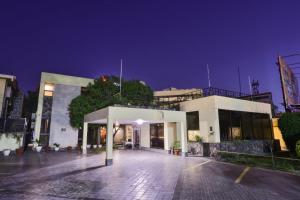 a large white building at night at Avari Boutique Multan in Multan