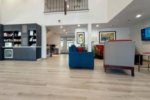 a lobby with chairs and tables in a building at Comfort Inn & Suites Sturbridge-Brimfield in Sturbridge