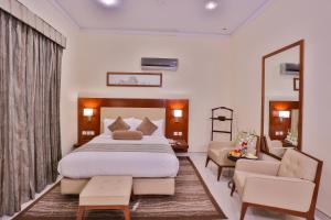 a bedroom with a large bed and a living room at Avari Boutique Multan in Multan +16 photos