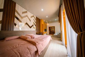 a bedroom with a large bed in a room at Bhumi Nawasena in Semalen +23 photos
