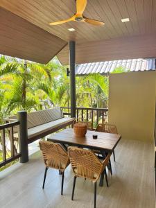a dining room with a table and chairs at Secret Cottages Chaweng Noi in Koh Samui
