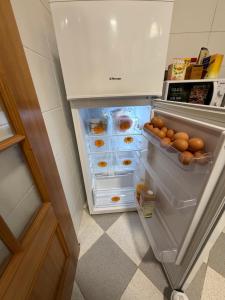 an open refrigerator with lots of eggs in it at LandS in Caniço +54 photos