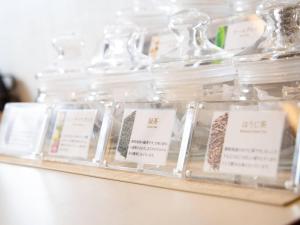 a shelf of glass jars with labels on them at Comfort Hotel ERA Tokyo Higashi Kanda in Tokyo