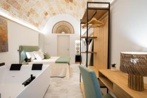 a hotel room with a bed and a bathroom at Celine Dimora e Suite in Copertino