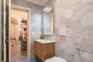 a bathroom with a sink and a toilet at Celine Dimora e Suite in Copertino +36 photos