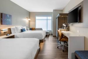 a hotel room with two beds and a desk at Cambria Hotel Mount Pleasant - Charleston in Charleston +58 photos