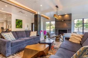 a living room with blue couches and a fireplace at Cambria Hotel Copper Mountain in Frisco