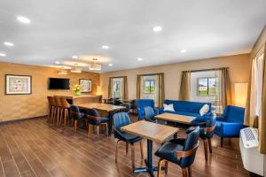 a waiting room with blue chairs and tables at Quality Inn Fairfield in Fairfield