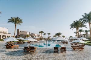 a resort with a pool with chairs and umbrellas at Sentido Akassia Beach Resort in Quseir