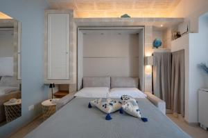 a bedroom with a bed with two pillows on it at Dimora Sofia, Charming House in Savelletri di Fasano